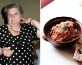 Una donna con un vestito a pois guarda verso la telecamera, accanto a una ciotola di trippa alla romana con pane.